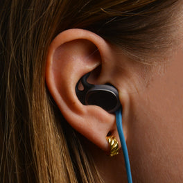 SEAR earplug seated in the ear with retention leash