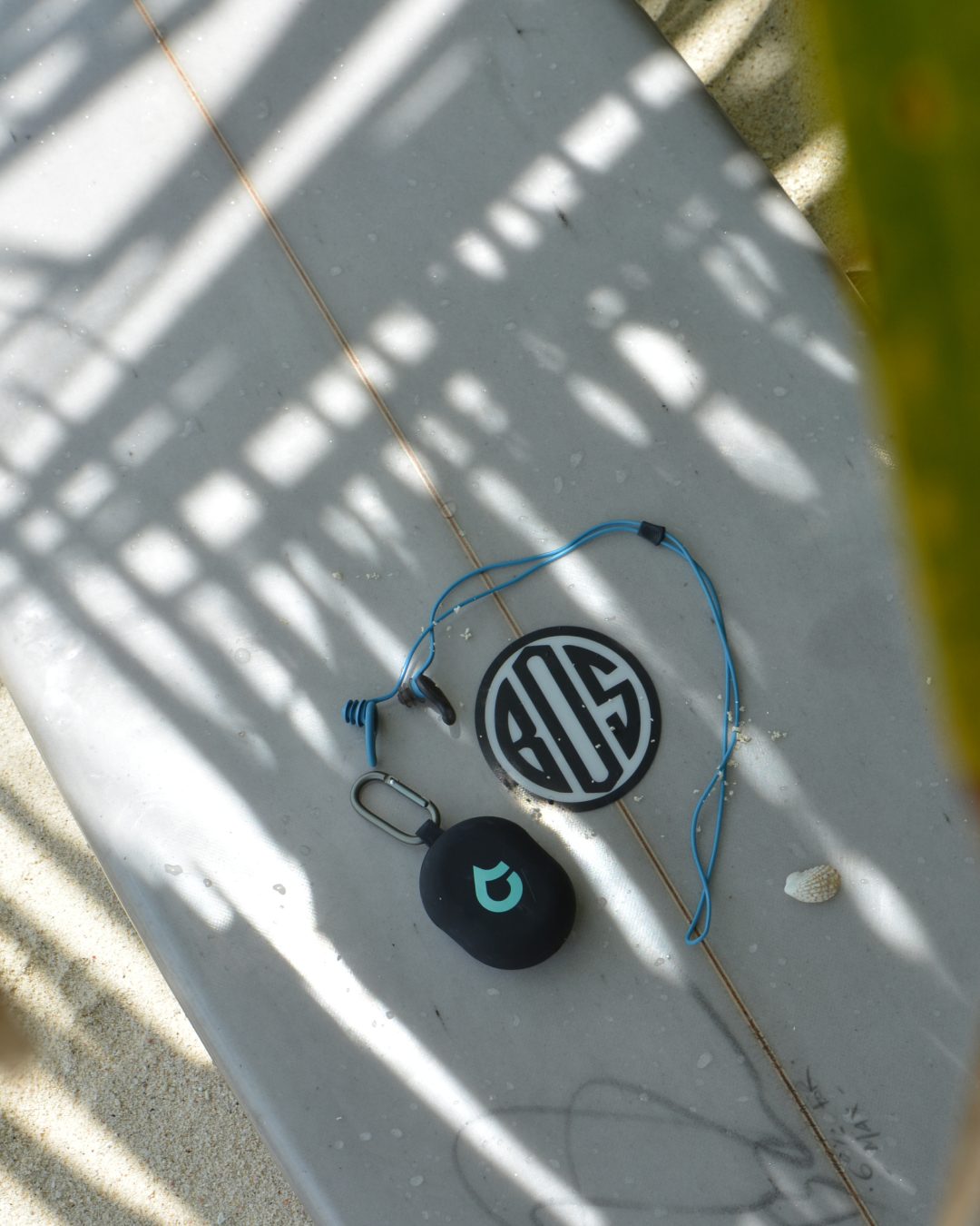 SEAR Plugs resting on a surfboard
